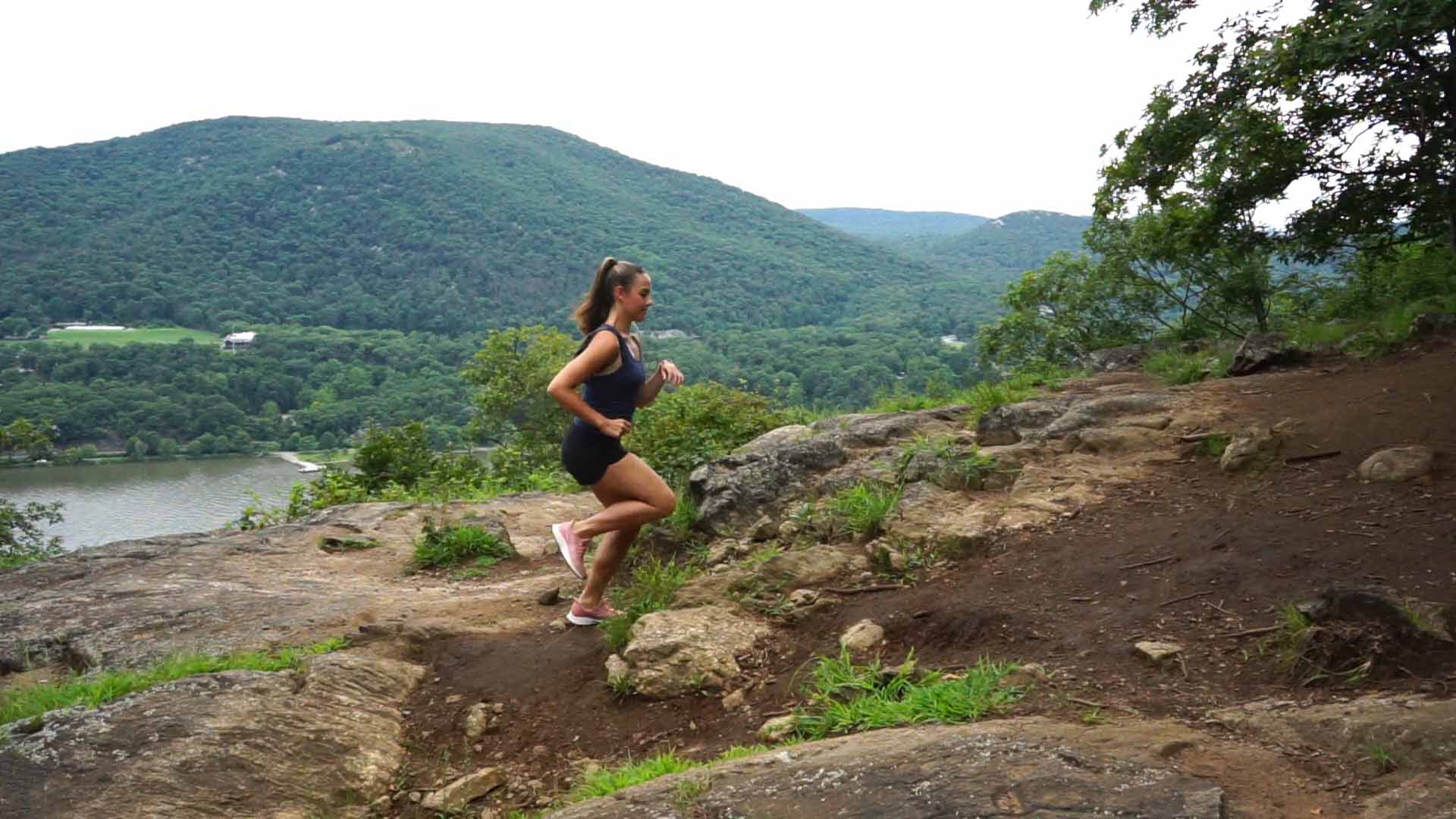 Trail runner climbing a rocky path
